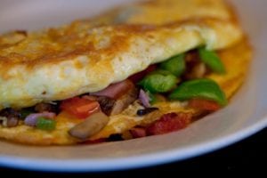 A tasty omelet with vegetables.