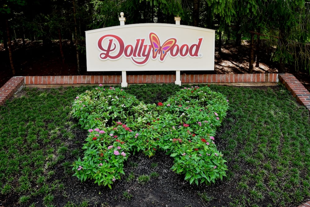 The Dollywood sign and a butterfly flower display.