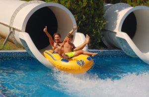 people riding a water slide